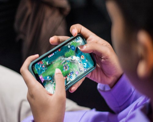 Angled smartphone showing the fictional Harbour Merge Expedition community game